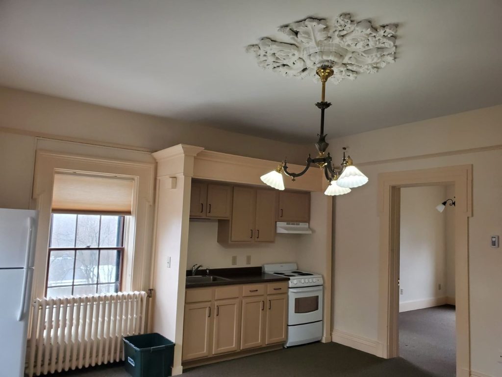 Typical kitchen with stove and cabinets at Adams House Apartments
