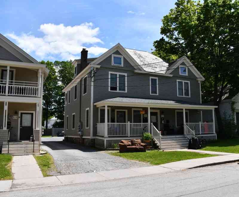 Two homes with apartments side-by-side as seen from Depot Street