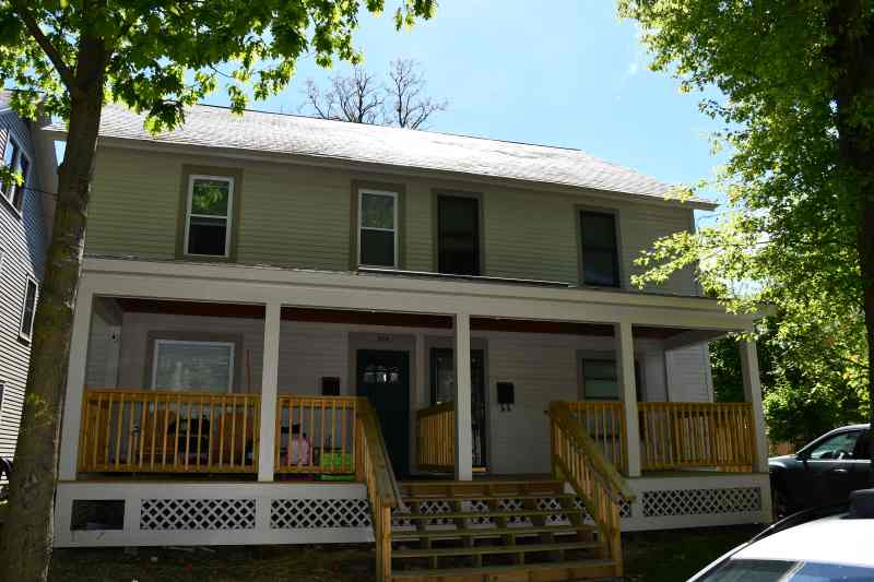 House with front porch and shade trees